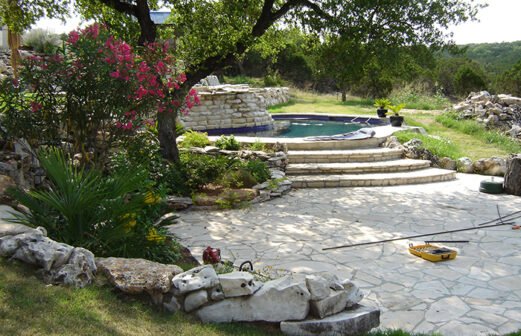 Native boulders, flagstone and chopped limestone mix to create beds, patios and steps--Fallen Oak
